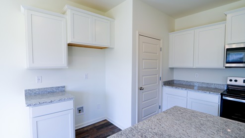 Bright and modern kitchen space with ample natural light, perfect for family gatherings and everyday cooking. The kitchen space is designed to be bright and modern, with plenty of natural light flooding in. It is an ideal setting for family gatherings as well as everyday cooking.