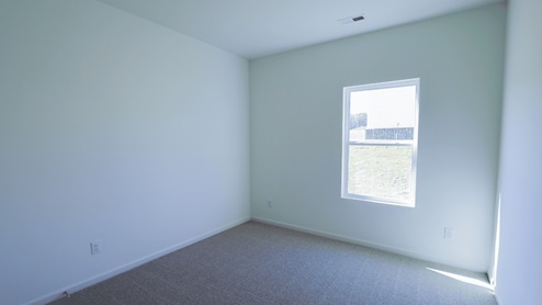 Bright and spacious empty room with natural light streaming through the window, perfect for interior design ideas.