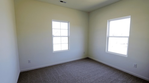 Bright and airy room featuring two windows that allow natural light to fill the space, perfect for a cozy and welcoming atmosphere. This room is bright and airy, with two windows that let in plenty of natural light. The abundance of natural light creates a cozy and welcoming atmosphere in the space.