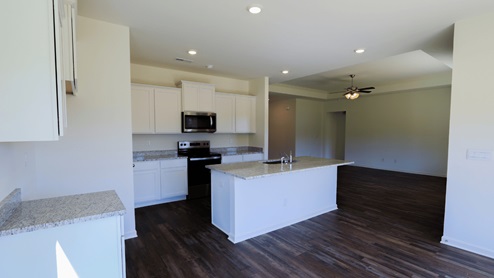 Modern kitchen with granite countertops and stainless-steel appliances, perfect for cooking and entertaining. The kitchen is equipped with granite countertops and stainless-steel appliances, making it ideal for both cooking and entertainment.