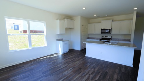 Modern kitchen with granite countertops and stainless-steel appliances, perfect for cooking and entertaining. The kitchen is equipped with granite countertops and stainless-steel appliances, making it ideal for both cooking and entertainment.