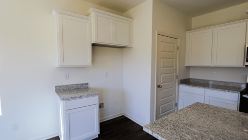 Bright and spacious kitchen featuring modern appliances and ample countertop space, perfect for cooking and entertaining. The kitchen is bright and spacious, with plenty of natural light and room to move around. It is equipped with modern appliances, making meal preparation convenient and efficient. There is ample countertop space, providing plenty of room for cooking and food preparation. This kitchen is perfect for both cooking and entertainment, with its inviting layout and functionality.