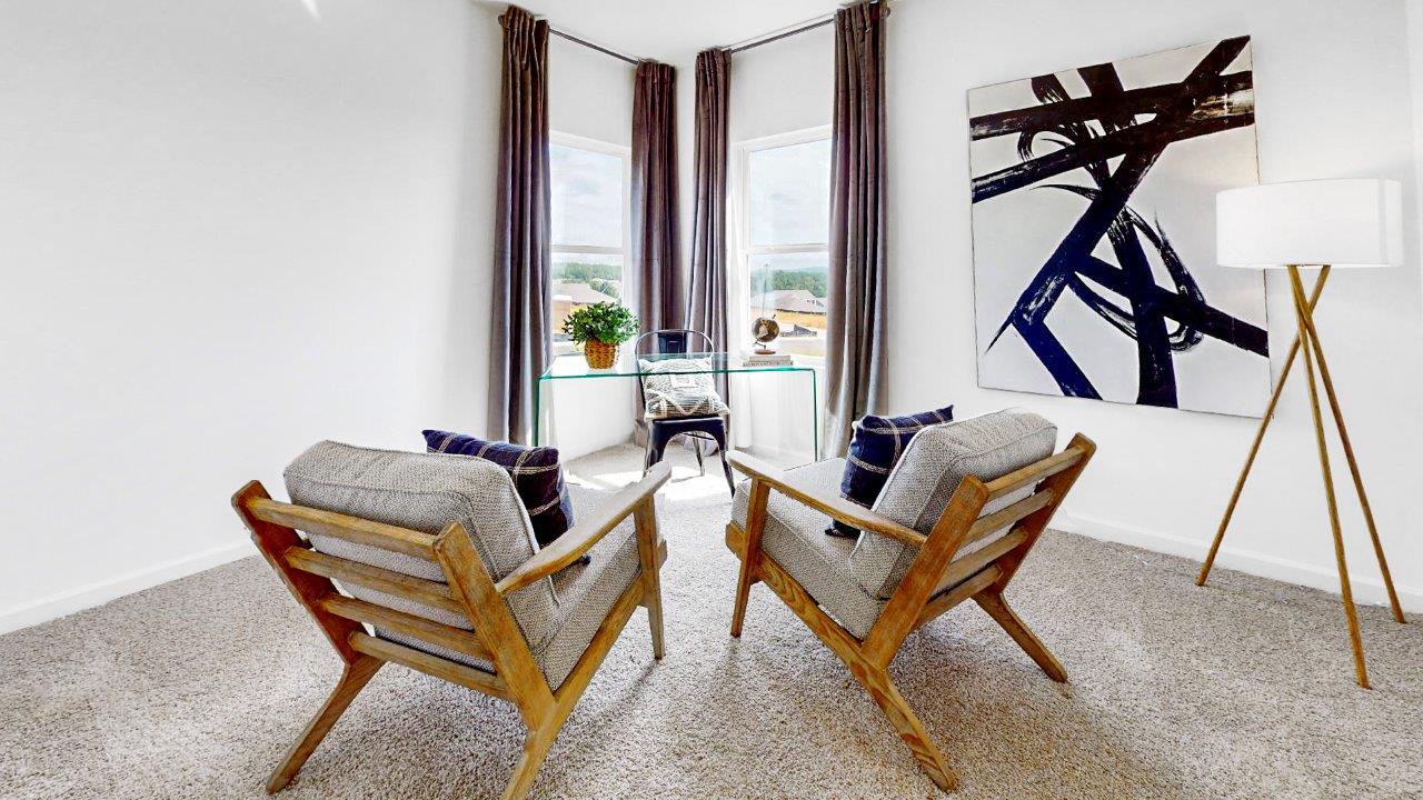 Guest bedroom is off the living room that is currently used as an office complete with desk and 2 guest chairs