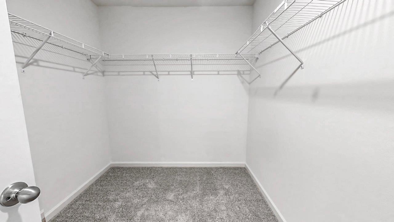 Primary bedroom walk in closet is located in the back of the bathroom with ample space for clothes