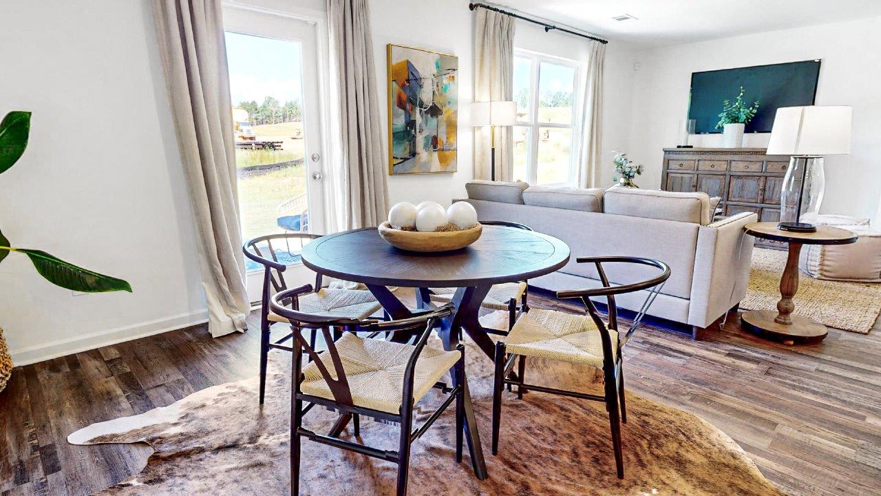 Large dining area that holds a large kitchen table and 6 chairs that opens to the kitchen