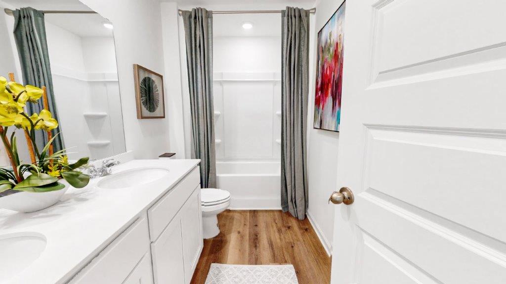Bathroom with a double vanity, and tub/ shower