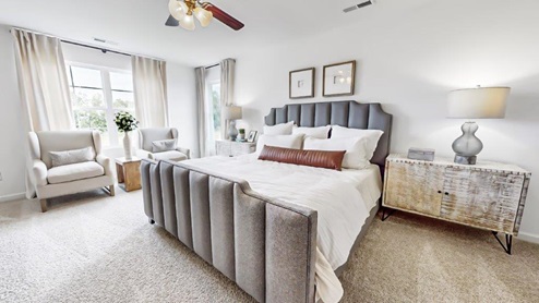 Carol – Primary Bedroom – The second level expansive primary bedroom consists of a large king sized bed, 2 oversized night tables, a dresser and two large guest chairs