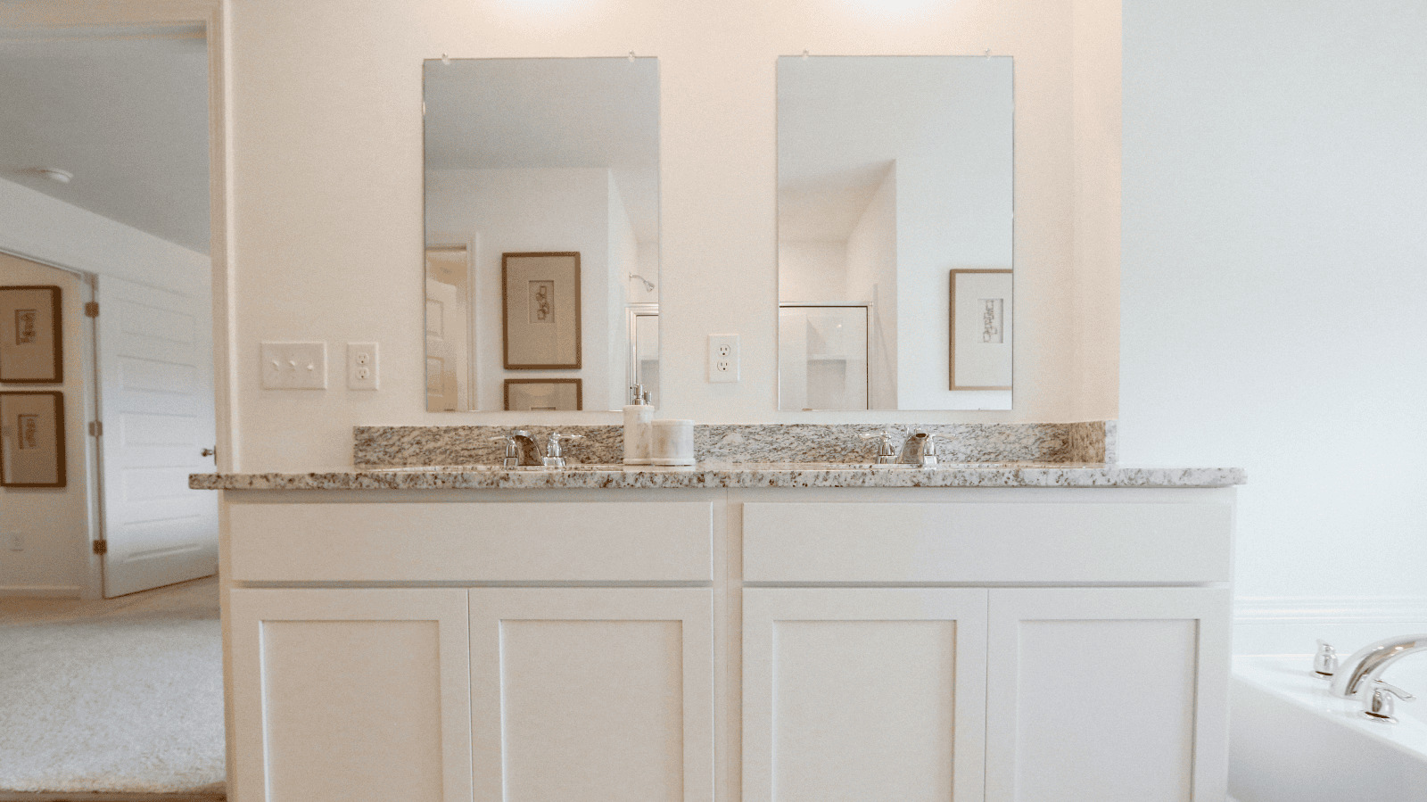 Tradition Package -    1tradition_kitchen: A contemporary kitchen equipped with a stainless-steel fridge, microwave, and electric stove.    2Traditionkitchen2: Side view of another kitchen with the dining room on the left and pantry door on the right.    3TraditionKitchen3: Perspective of the kitchen from the left side of the kitchen island with a view of the front hallway and bar stools.    4TraditionSink: A kitchen island with a farmhouse sink and a view to the dining room.    5traditionalbathroom: A double vanity featuring two mirrors and granite countertops.    6solarboard1: A close-up image of solar board   7solarboard2: A view from the inside of the trusses and solar board.