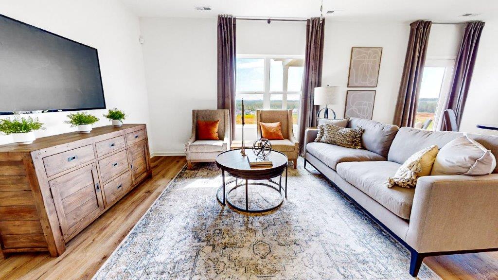 Large sectional couch, 2 chairs and and media consol complete the large spacious living room