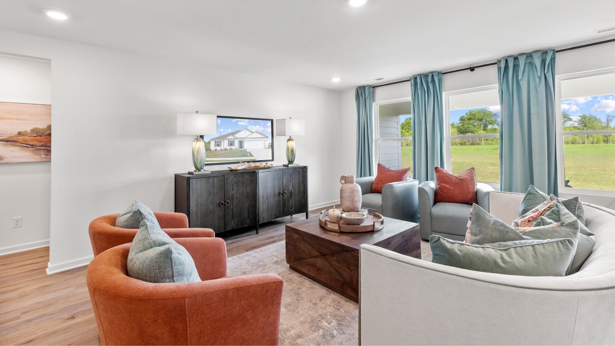 The large living room has space for basically any size couch, a large coffee table, and two large armchairs.