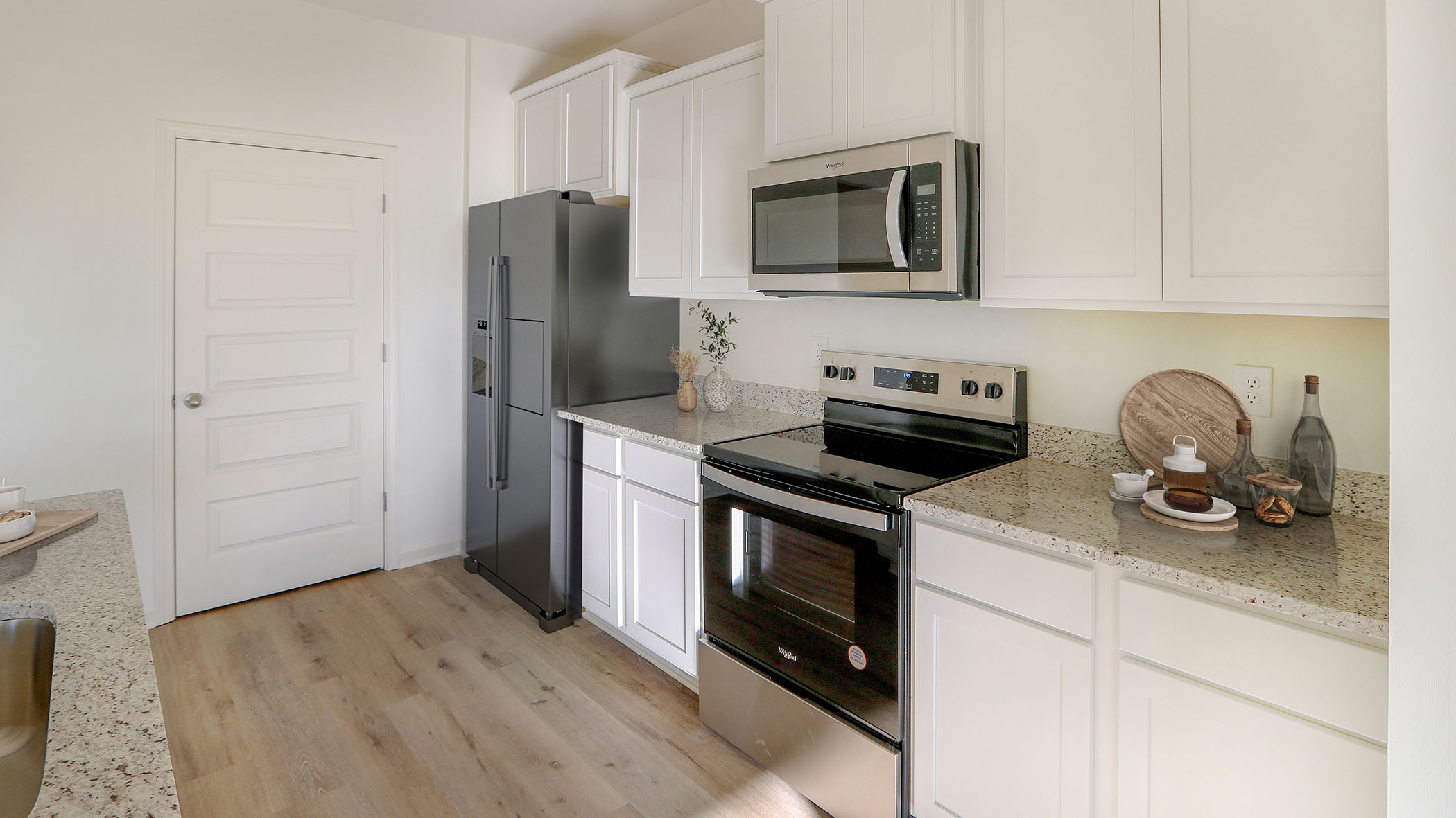 A modern kitchen featuring stainless steel appliances and elegant granite countertops, showcasing a sleek and stylish design.
