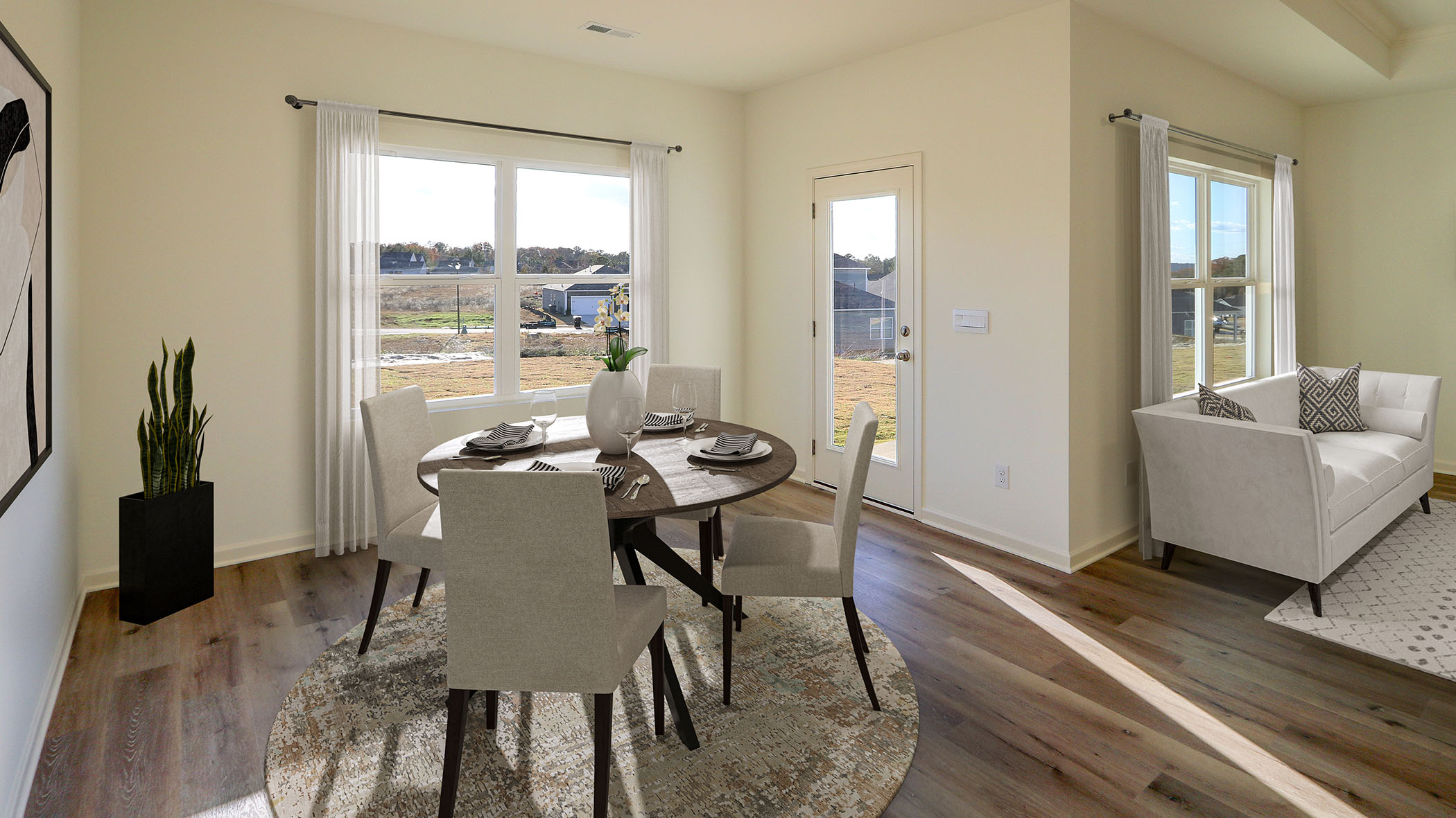 A spacious dining and living room featuring elegant hardwood floors, creating a warm and inviting atmosphere.