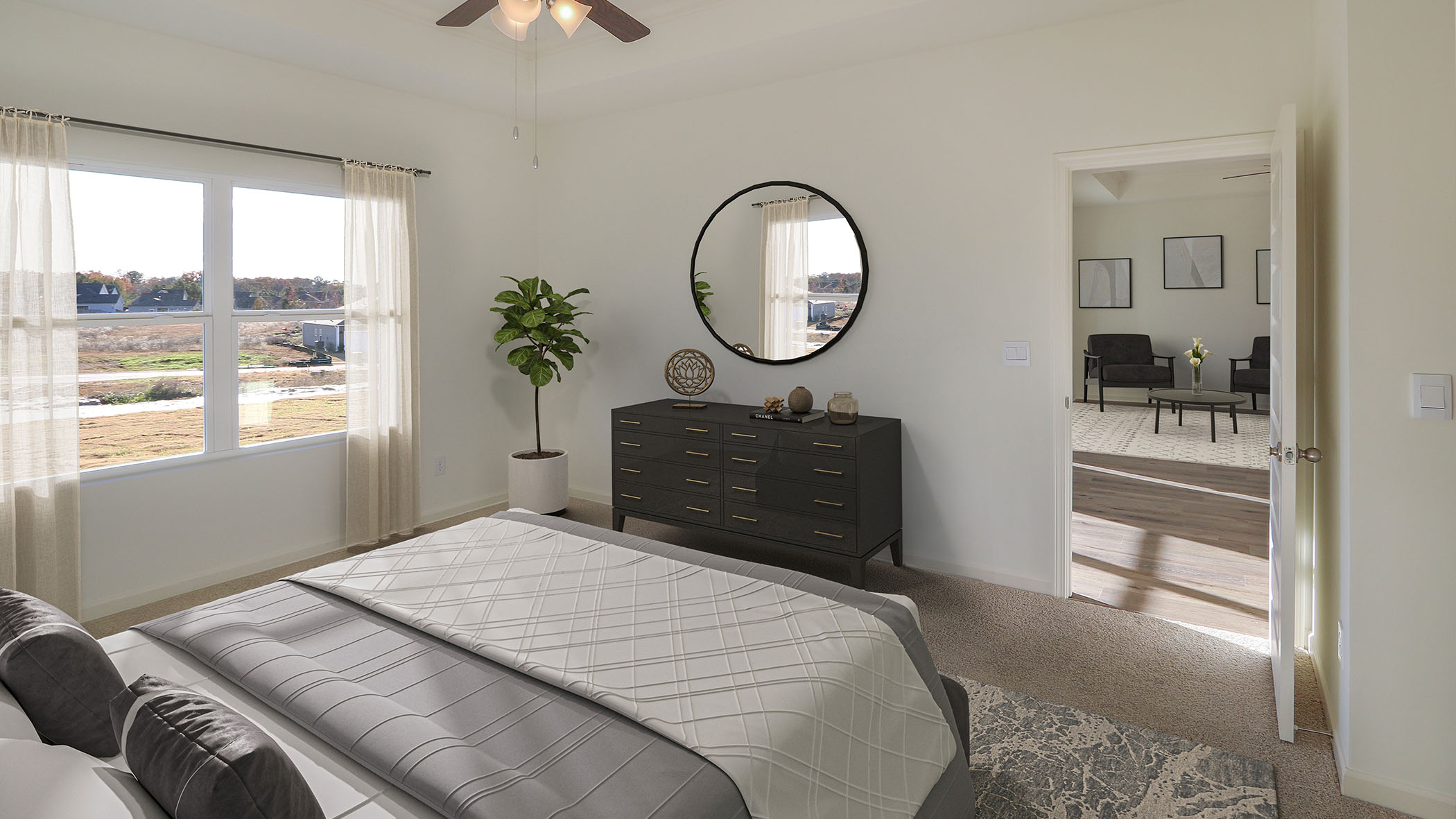 A spacious bedroom featuring a large bed and a stylish mirror reflecting the room's elegant decor.