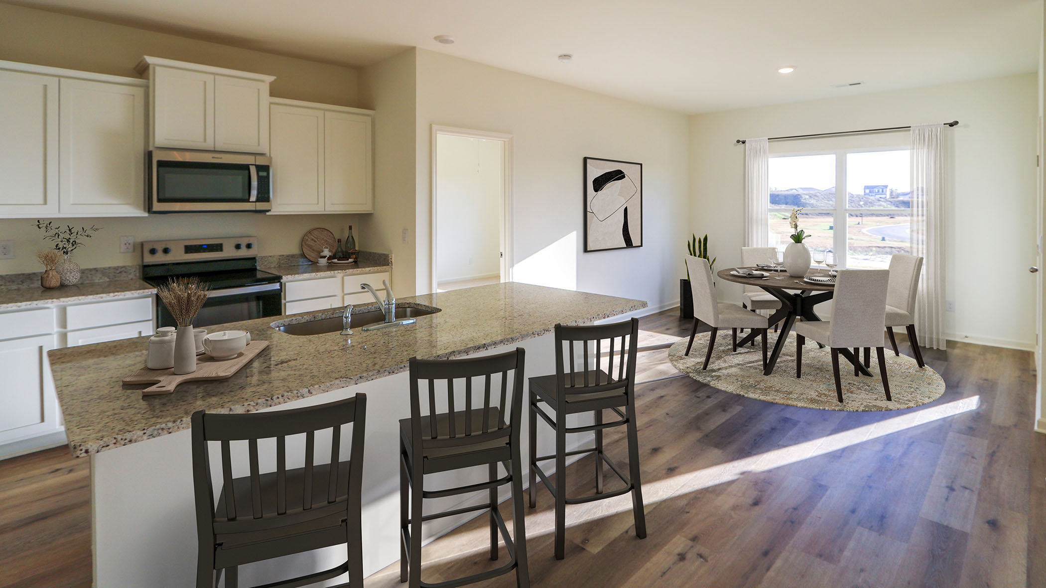 A modern kitchen featuring a dining area with bar stools, showcasing a blend of functionality and style.