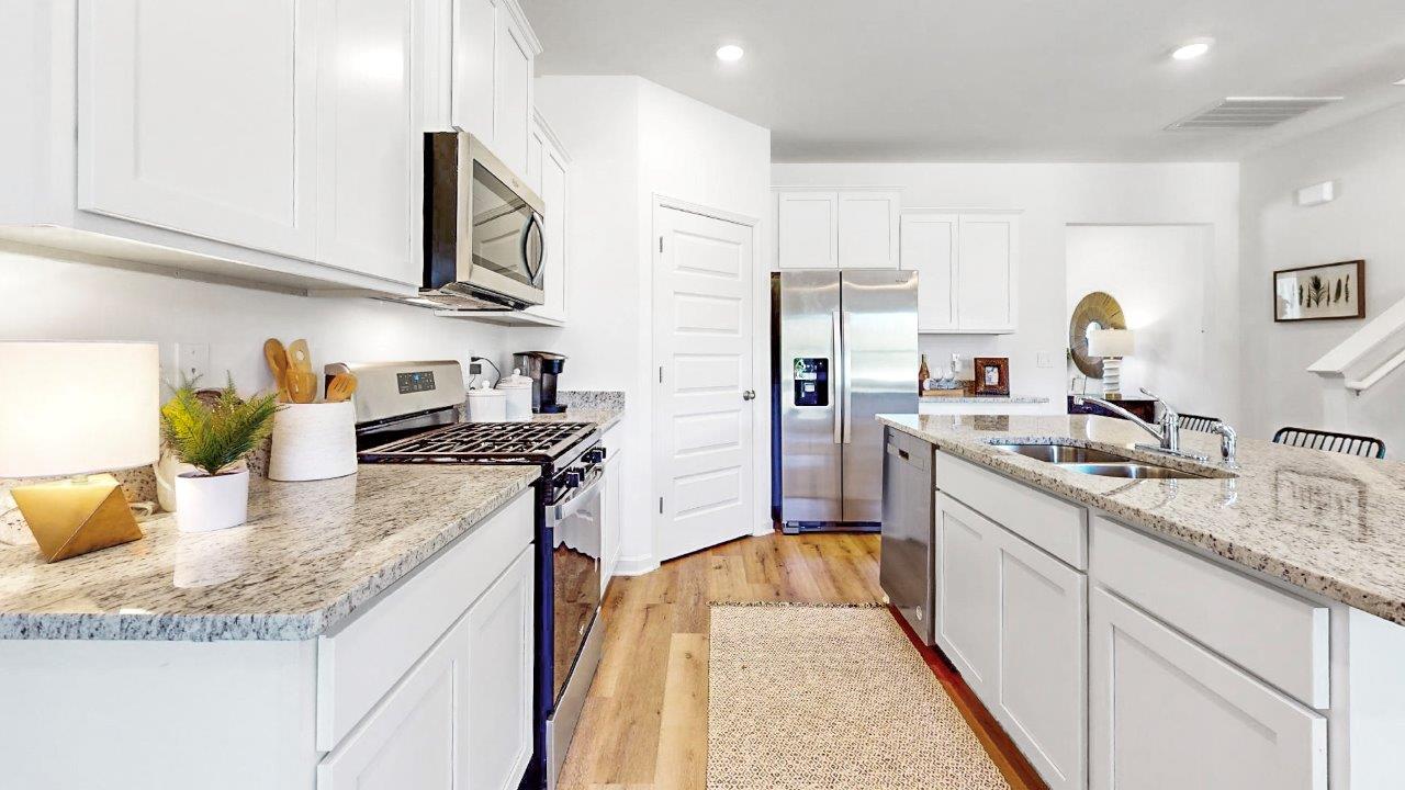 Chefs kitchen with white cabinets and granite counter tops
