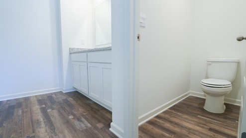 The toilet has it's own door enclosure.