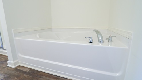 The primary bathroom features a separate garden tub.