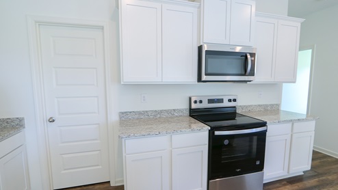 The kitchen features ample counter area and plenty of cabinet storage space.