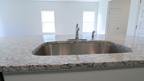 The eat-in island also has a stainless steel sink.