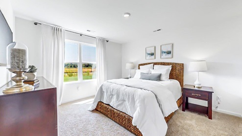 Freeport – Primary Bedroom – the primary suite features a king sized bed, two nightstand and a dresser