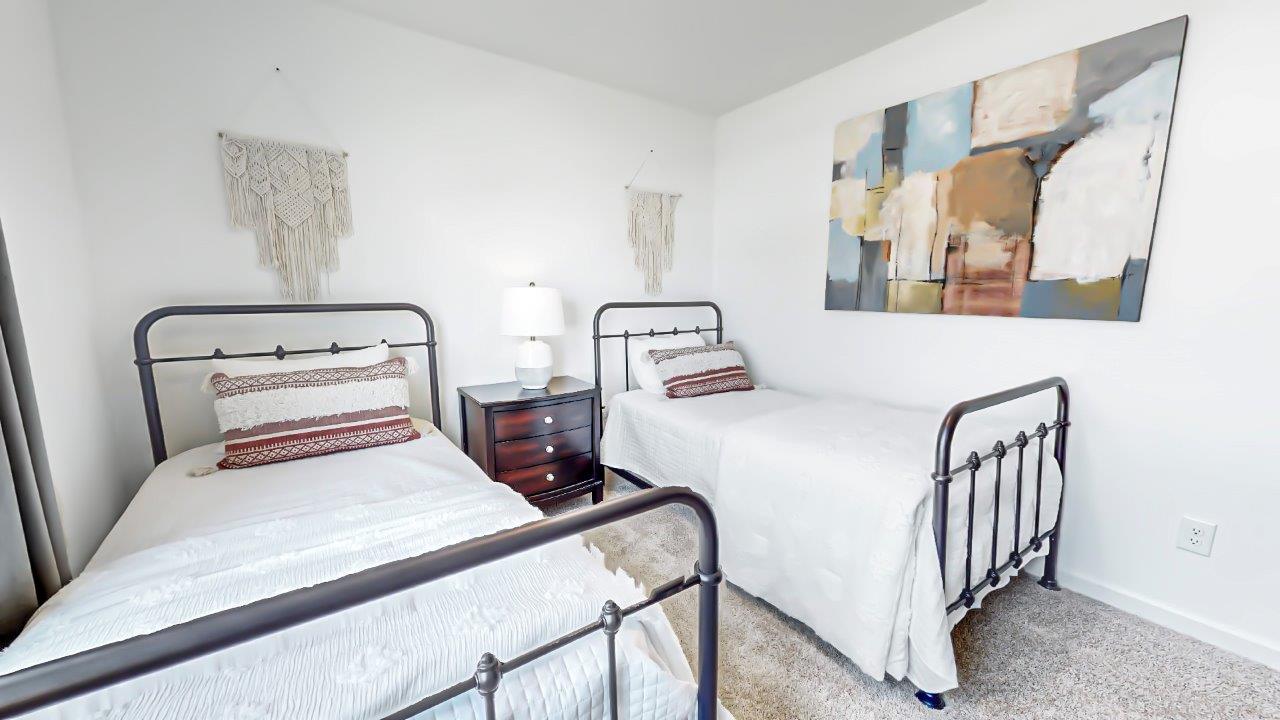 Freeport – Bedroom 3 – the third bedroom features two twin beds that are separated by a nightstand