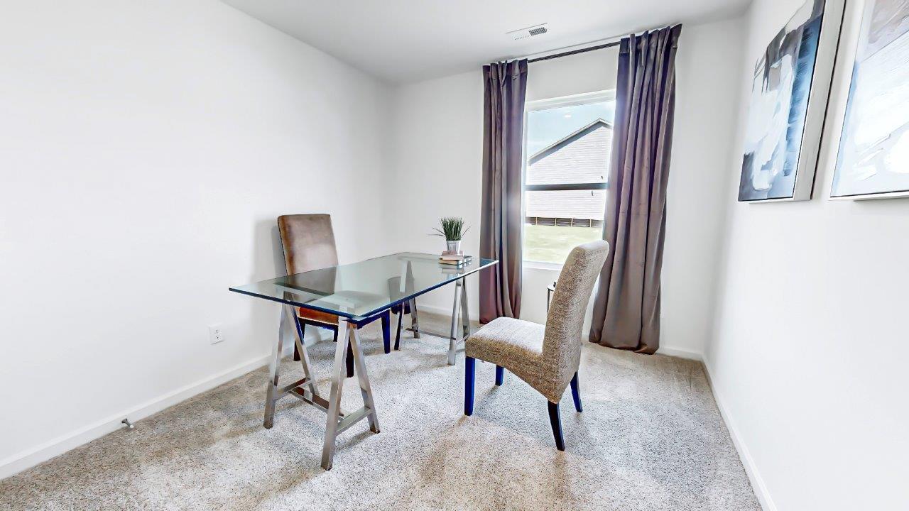 Fourth bedroom is currently being used as an office and contains a desk with a guest chair