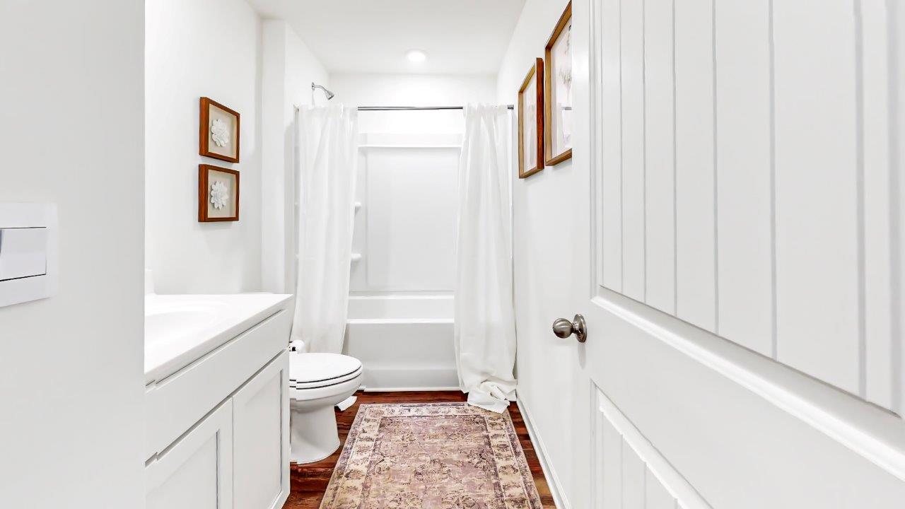 Second bathroom is a full bathroom with a vanity with sink, toilet and a a tub/shower