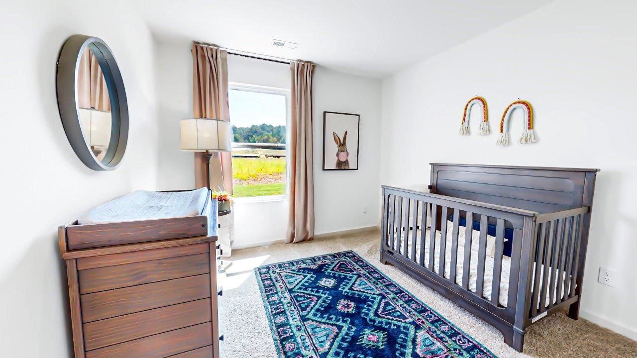 Freeport – Bedroom 2 – The second bedroom is currently a nursery with a crib and dresser with a changing top
