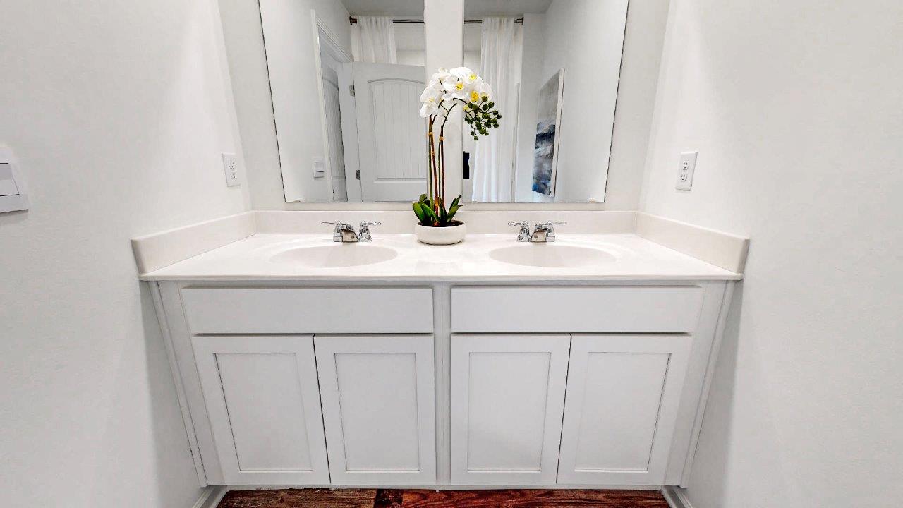 Primary bathroom featuring a Large double vanity with mirrors