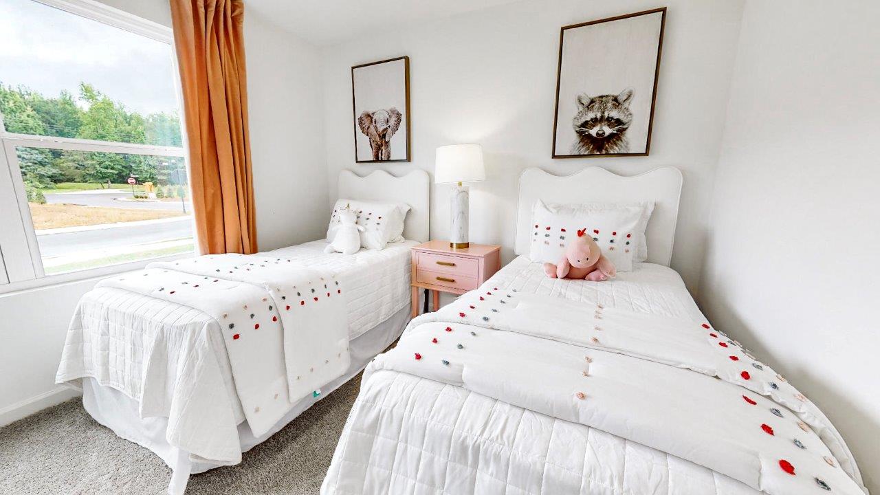 Guest bedroom features two twin beds with a nightstand