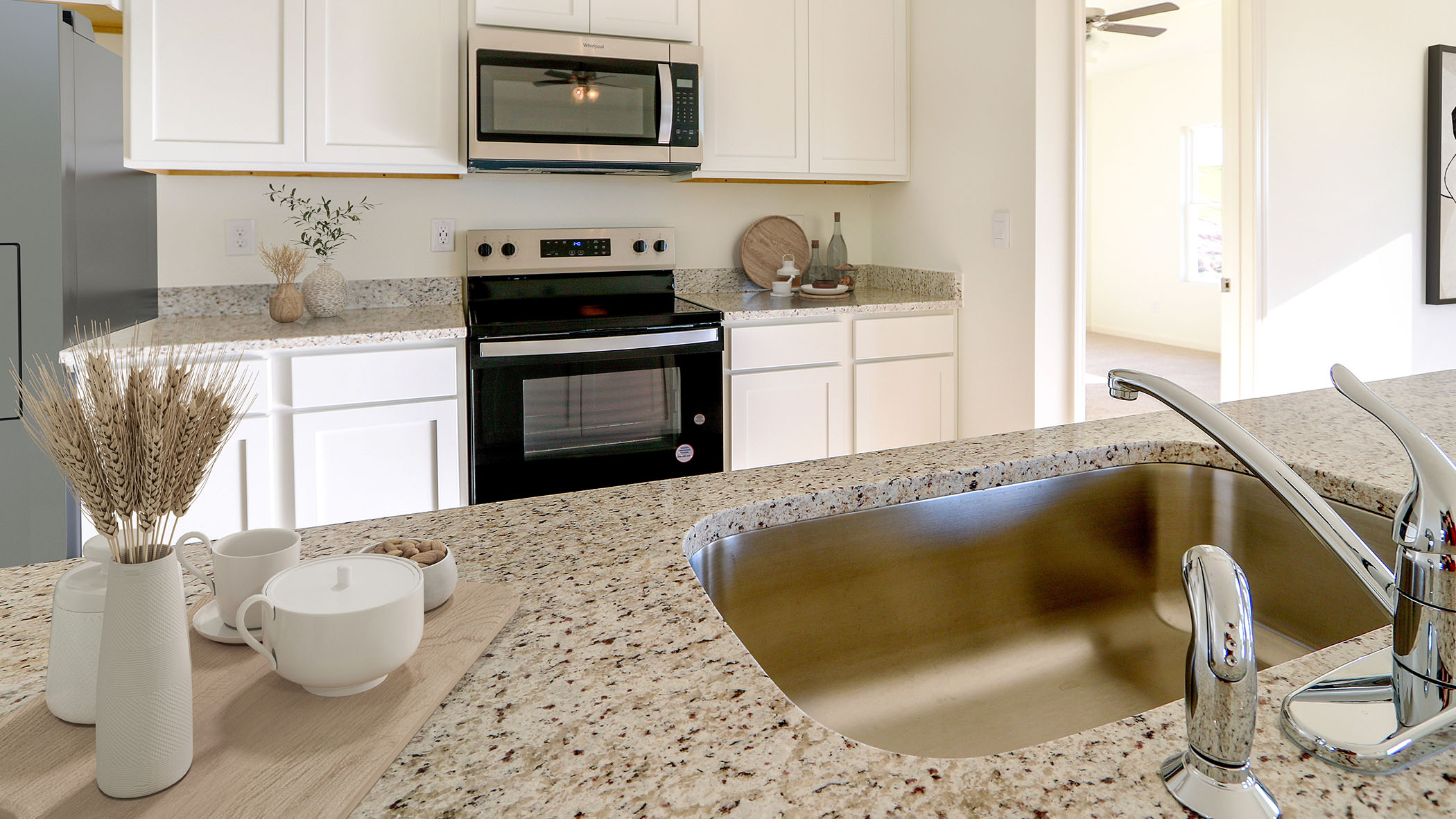 A modern kitchen featuring a sink, stove, and refrigerator, showcasing a functional and organized cooking space.