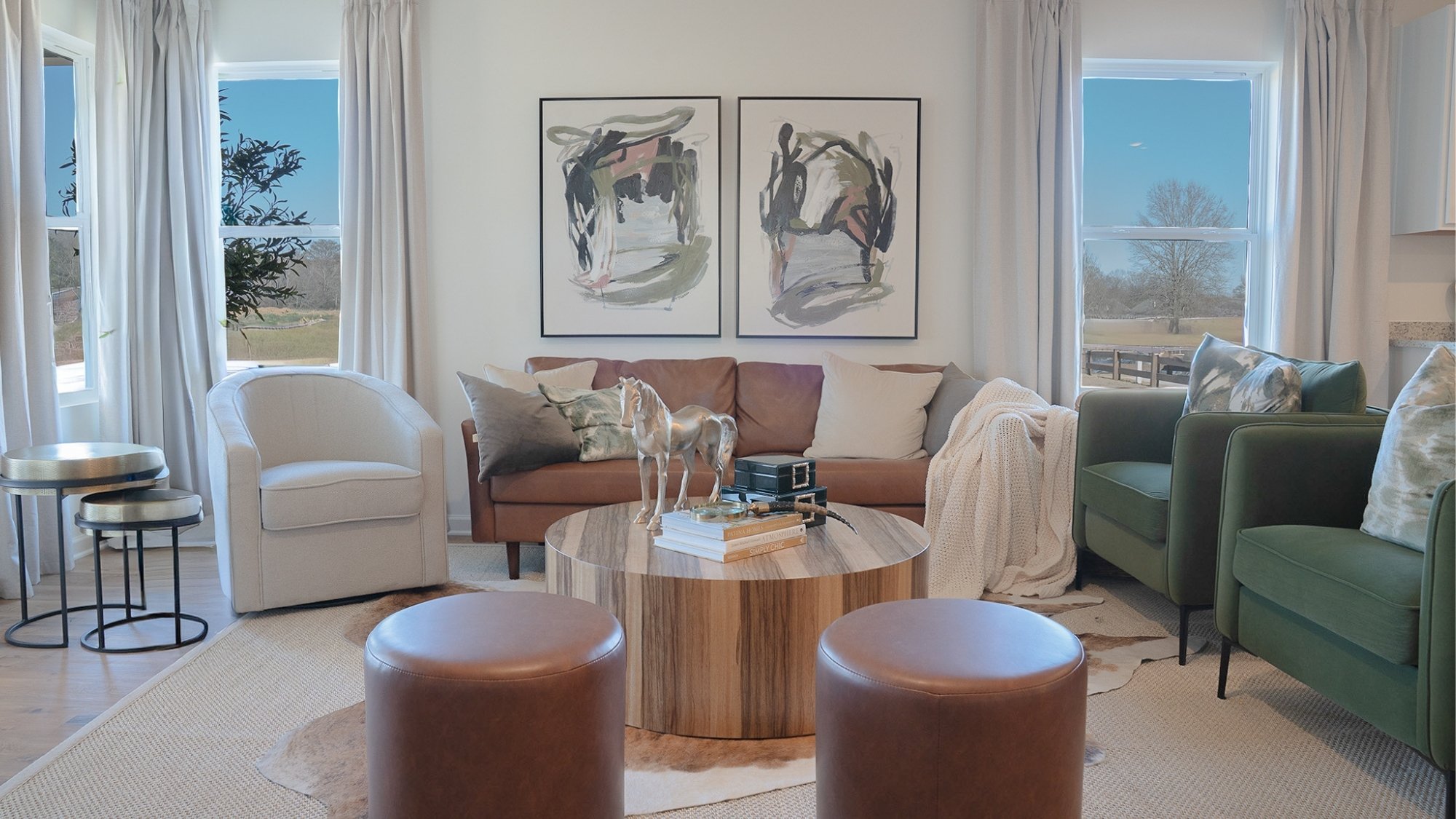 The large windows flood the living room space with natural light, providing a warmth the whole area can enjoy.