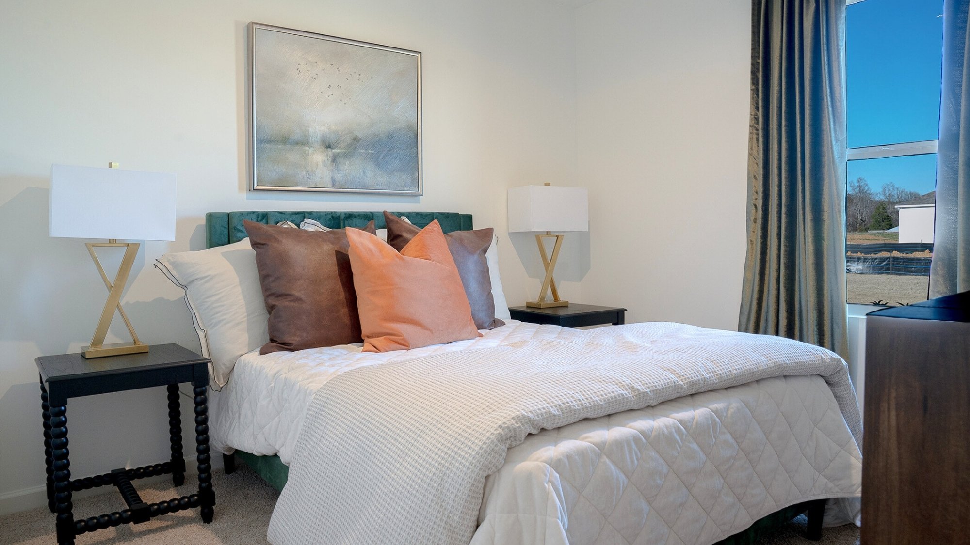 The primary bedroom features ample space for a queen bed, 2 nightstands, and a large dresser  with large windows allowing natural light to fill the whole space.
