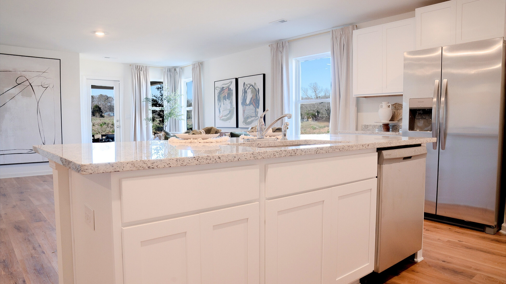 The roomy island features ample room for 3 barstools, and a built in sink.