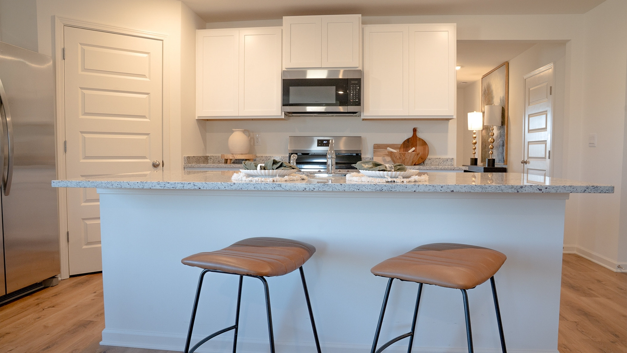 The roomy island features ample room for 3 barstools, and a built in sink.