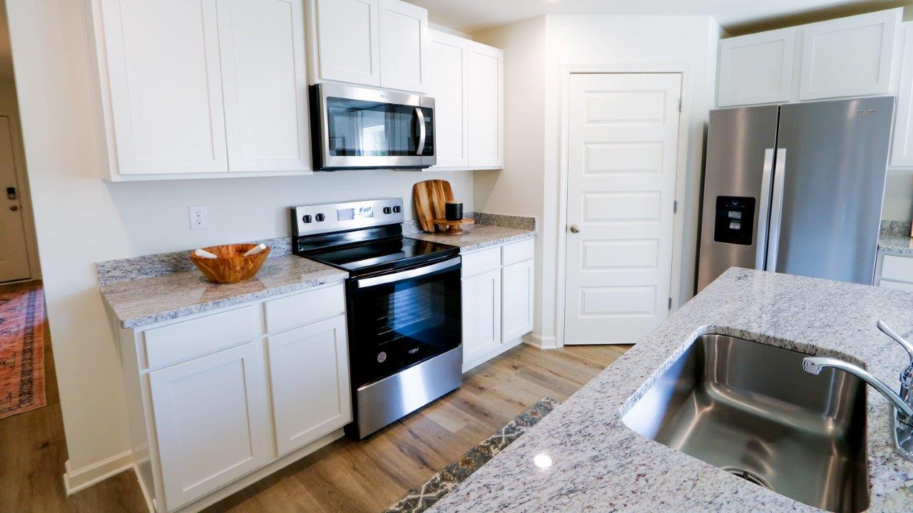 The Lakeside floor plan presents an exquisite 5-bedroom, 3-bathroom residence. The kitchen boasts a stunning design featuring quartz countertops, an undermount sink, a spacious island bar, top-of-the-line stainless-steel appliances, and a convenient corner pantry. Seamlessly connected to the family room, this kitchen is ideal for hosting gatherings and enjoying quality time with loved ones. Adjacent to the kitchen, you'll find a delightful breakfast nook and a separate dining area. The home is bathed in abundant natural light, creating a serene and inviting atmosphere. Step outside onto the expansive porch that leads to the backyard, further enhancing the relaxing ambiance. Bedroom 1 offers ample space and is accompanied by an adjoining bath that showcases a double vanity, a generous shower, and a walk-in closet. The home is crafted with superior materials and workmanship, showcasing meticulous attention to detail, and is backed by a one-year builder's warranty. Additionally, your new home includes our cutting-edge smart home technology package! A D.R. Horton Smart Home is equipped with an array of advanced features, including a Honeywell Z-Wave programmable thermostat, a Kwikset Z-Wave door lock, an Eaton Corporation Z-Wave wireless switch, a Qolsys, Inc. touchscreen Smart Home control device, an Alarm.com automation platform, a SkyBell video doorbell, and an Amazon Echo Dot.* For more information, please consult a New Home Sales Agent.