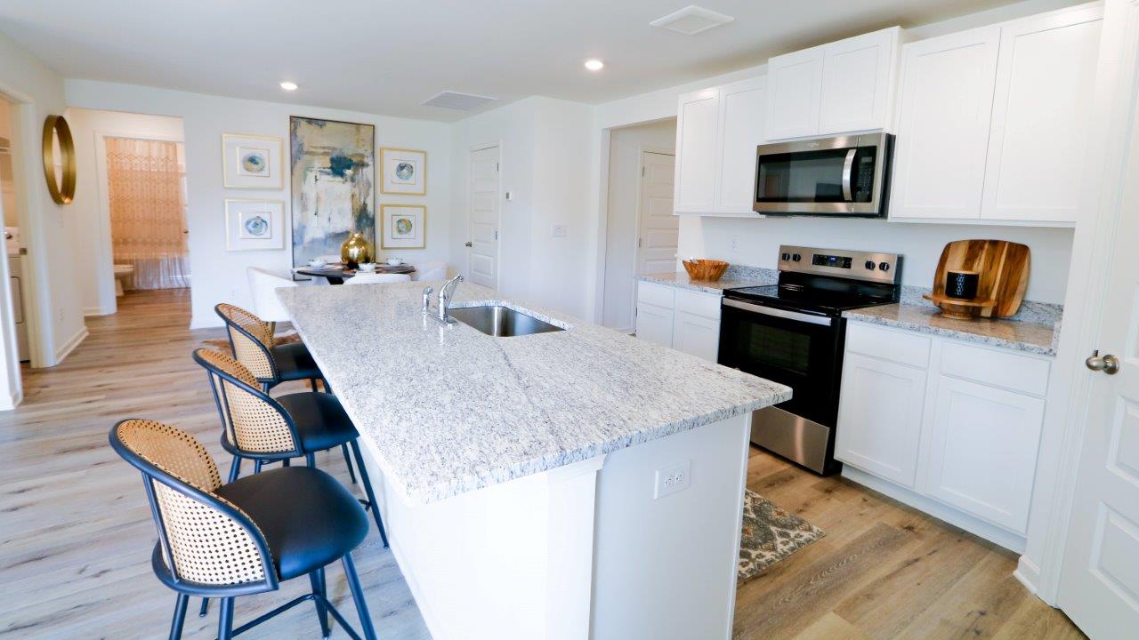 The Lakeside floor plan presents an exquisite 5-bedroom, 3-bathroom residence. The kitchen boasts a stunning design featuring quartz countertops, an undermount sink, a spacious island bar, top-of-the-line stainless-steel appliances, and a convenient corner pantry. Seamlessly connected to the family room, this kitchen is ideal for hosting gatherings and enjoying quality time with loved ones. Adjacent to the kitchen, you'll find a delightful breakfast nook and a separate dining area. The home is bathed in abundant natural light, creating a serene and inviting atmosphere. Step outside onto the expansive porch that leads to the backyard, further enhancing the relaxing ambiance. Bedroom 1 offers ample space and is accompanied by an adjoining bath that showcases a double vanity, a generous shower, and a walk-in closet. The home is crafted with superior materials and workmanship, showcasing meticulous attention to detail, and is backed by a one-year builder's warranty. Additionally, your new home includes our cutting-edge smart home technology package! A D.R. Horton Smart Home is equipped with an array of advanced features, including a Honeywell Z-Wave programmable thermostat, a Kwikset Z-Wave door lock, an Eaton Corporation Z-Wave wireless switch, a Qolsys, Inc. touchscreen Smart Home control device, an Alarm.com automation platform, a SkyBell video doorbell, and an Amazon Echo Dot.* For more information, please consult a New Home Sales Agent.