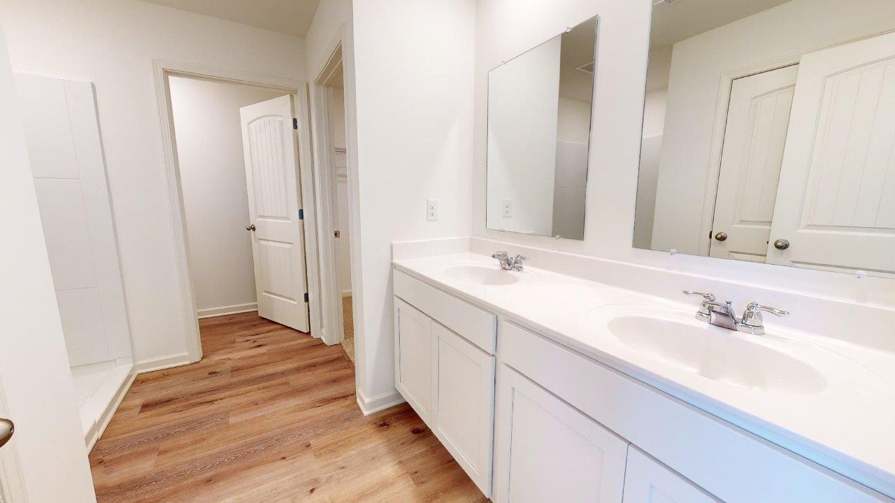 Lakeside – primary bathroom – 1 – large primary bathroom with double vanity sinks