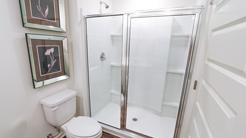 Freeport – Primary Bathroom – the primary bathroom features a double sink vanity, toilet and tub shower