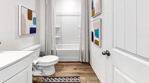the second bathroom is between bedroom 3 and 4 is a full bathroom that has a tub shower, toilet and vanity