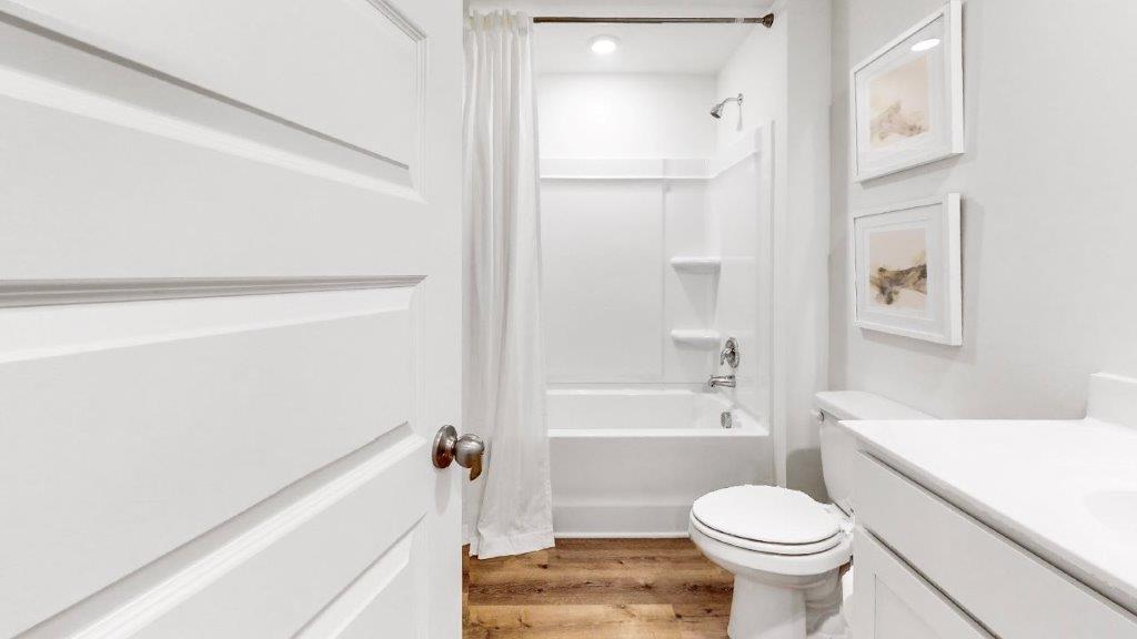 12. Cali – Bedroom 2- the second bedroom features a bed with 2 nightstands, a large window and accent chair