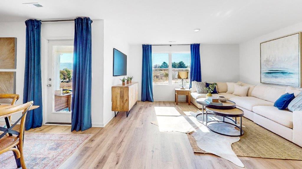 4. Cali – Living Room – 3 – a different view of the living room that shows part of the living room that opens to the dining room and the kitchen