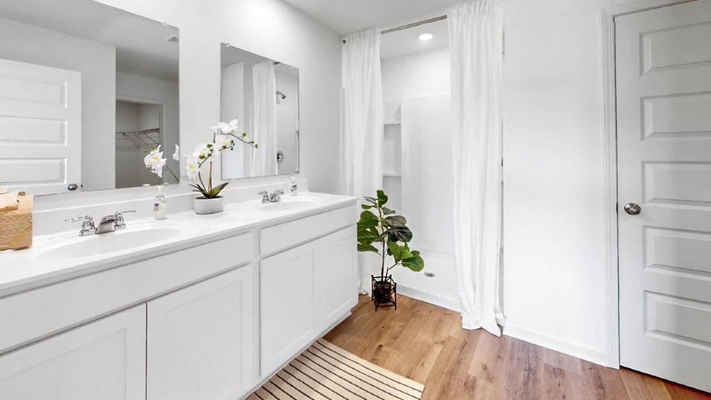 6. Cali – Kitchen – 1 – An large open concept kitchen that features stainless steel appliances, and oversized kitchen island with barstools, and a walk in pantry