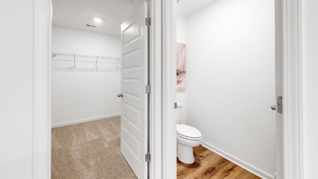 8. Cali – Primary bedroom – 1 – the large primary bedroom shows off ample space with a large king bed, 2 nightstand and a large double window that overlooks the backyard