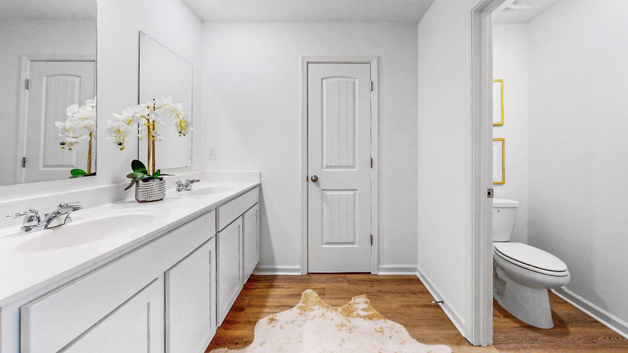 11. Elston – Primary bathroom – the large primary bathroom shows a double vanity with separate water closet