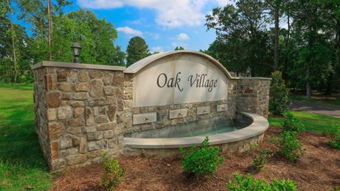 The Oak Village new home community entrance sign.