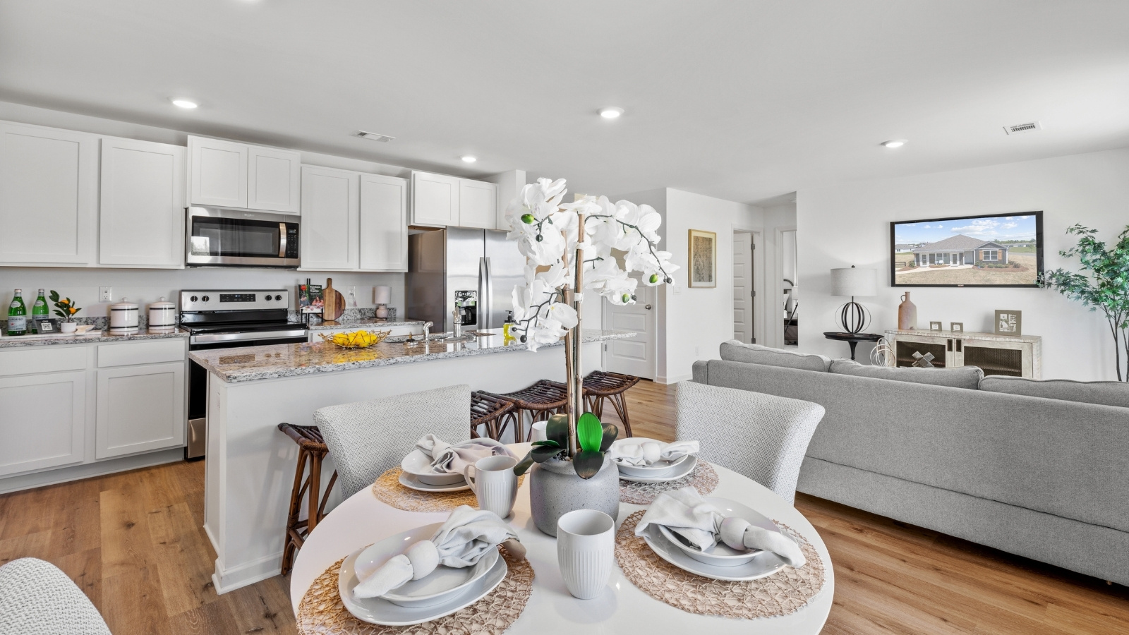 Breakfast table with 4 chairs that opens into the living room and kitchen.