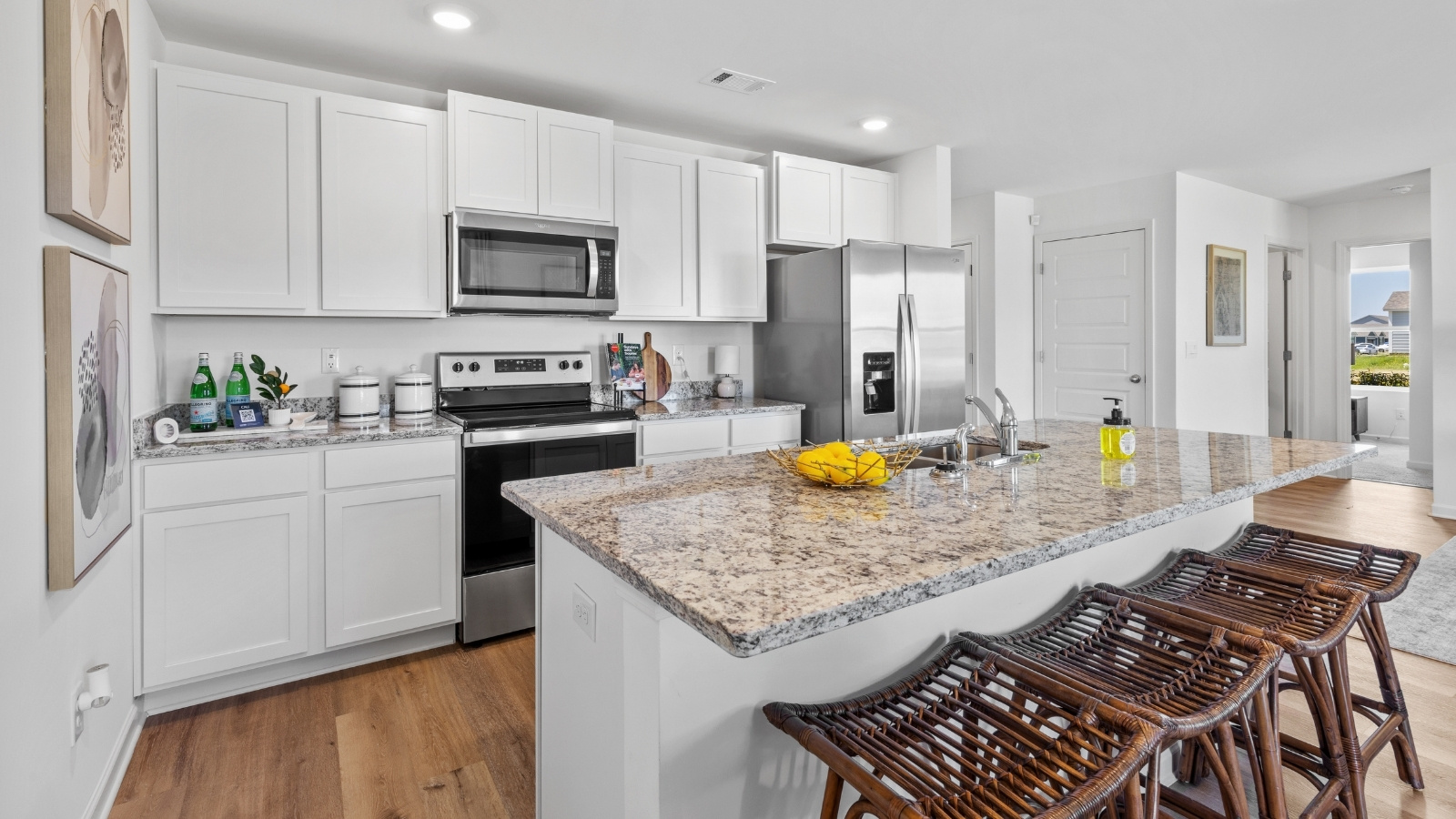 Well-appointed kitchen with stainless steel finishes, large counter space, and an open flow into the dining and living areas.