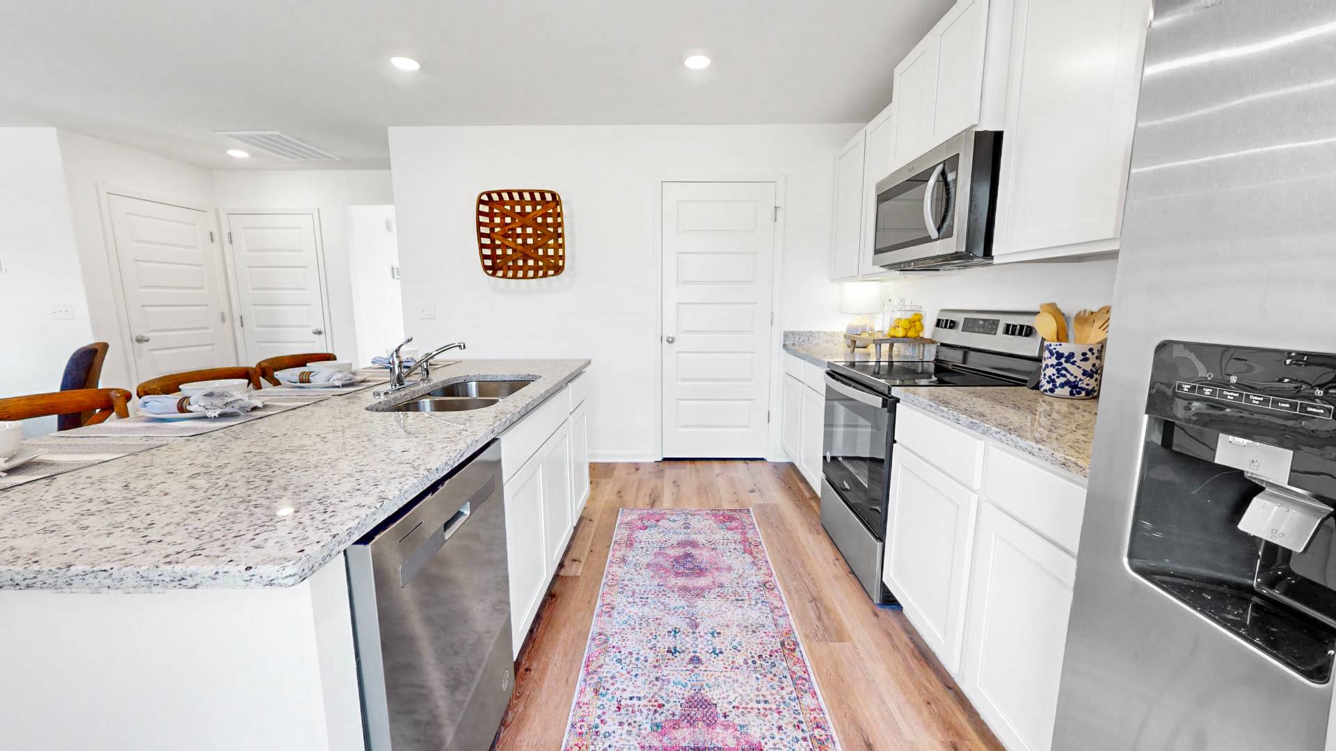The kitchen features stainless steel appliances. There is a door that leads to the walk-in pantry.