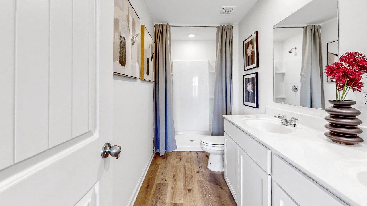 the Primary bathroom features a double vanity and a walk in shower
